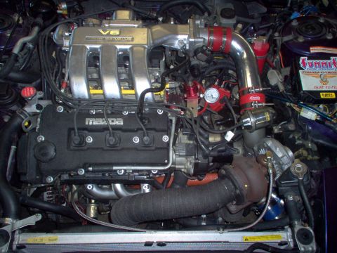 1996 Ford Probe - Mazda V6 engine bay modified with turbocharger and related components. Summit Racing battery is also visible.