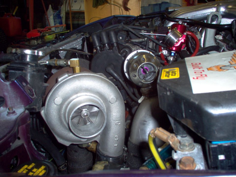 Turbocharger and blow-off valve installed in a car engine bay