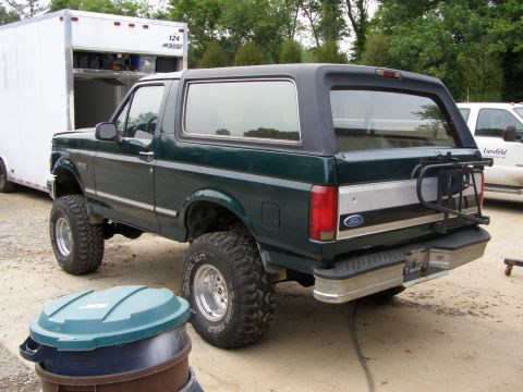 1993 Ford Bronco - This lifted 1993 Ford Bronco is shown from the rear three-quarter view, a spare tire carrier mounted on the back.