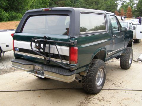 1993 Ford Bronco - Rear view of a green 1993 Ford Bronco with a spare tire carrier.