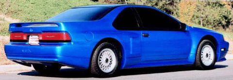 1987 Ford Thunderbird - Rear view of a blue 1987 Ford Thunderbird coupe with a spoiler and custom wheels.