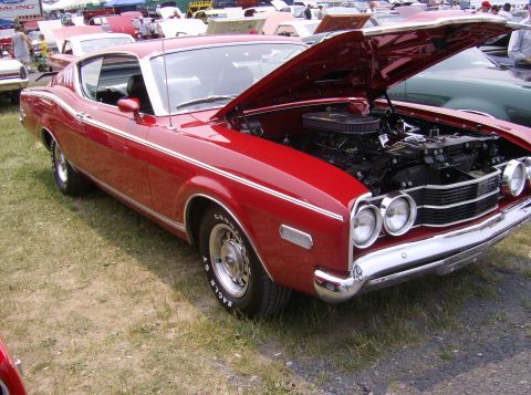 1970 Ford Ranchero - This red 1970 Ford Ranchero is displayed with its hood open, revealing the engine compartment.
