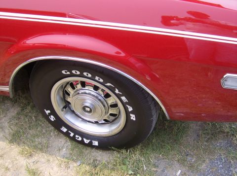 1970 Ford Ranchero - Side view of a 1970 Ford Ranchero's fender and wheel, showing chrome trim and a Goodyear tire.