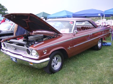 1970 Ford Ranchero - A classic Ford Galaxie 500 is displayed with its hood up at an outdoor car show.