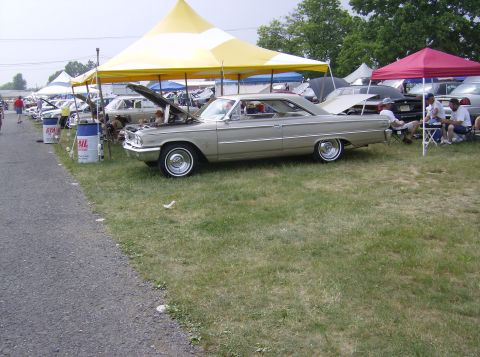 1970 Ford Ranchero - A 1963 Ford Galaxie 500 is displayed at a car show with its hood open.