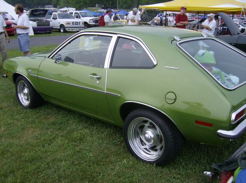 1970 Ford Ranchero - A green Ford Pinto coupe, not a 1970 Ford Ranchero, is displayed on a grassy field with other vehicles in the background.
