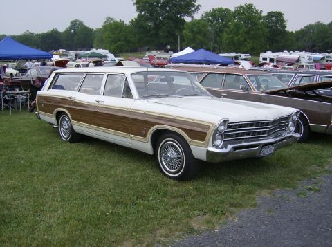 1970 Ford Ranchero - This station wagon, likely a 1967 model, is parked on a grassy field with other vehicles and tents in the background.