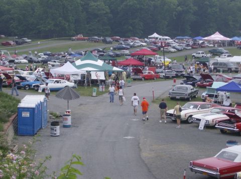 1970 Ford Ranchero - A large gathering of vehicles and attendees at an outdoor car show event.