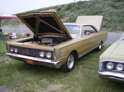 1970 Ford Ranchero - Gold 1967 Mercury Cougar shows off its engine bay at an outdoor car show.