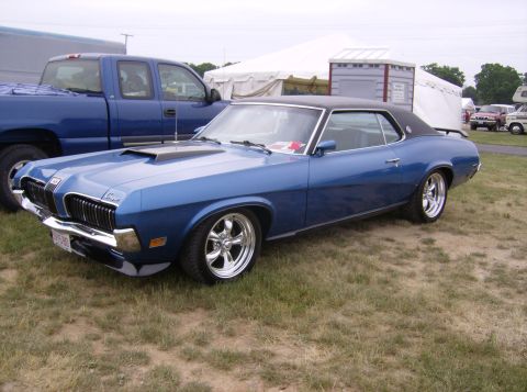 1970 Ford Ranchero - 1970 Mercury Cougar XR7 coupe, not a Ford Ranchero, parked next to a pickup truck.