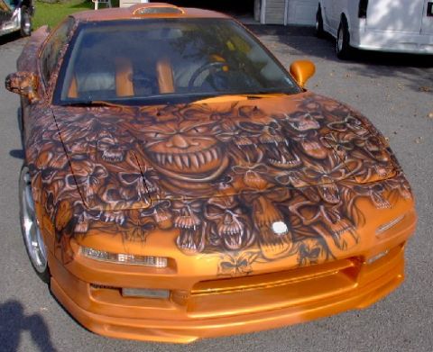 1978 Ford Mustang II - This sports car features an elaborate airbrush design of skulls and a monstrous face on its hood.