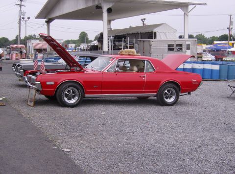 1970 Ford Ranchero - Red 1969 Mercury Cougar XR7 at an outdoor event, hood and trunk open.