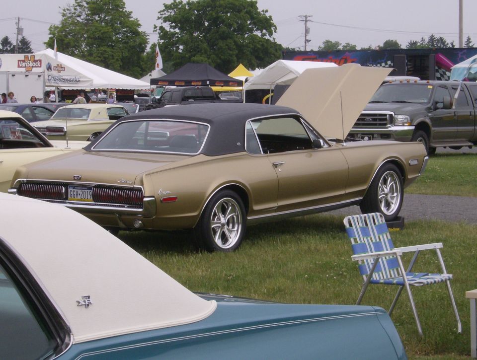 Gold 1968 Mercury Cougar XR7 with hood open, rear 3/4 view