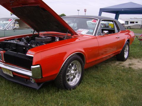 1970 Ford Ranchero - Red 1969 Mercury Cougar parked on grass, hood open to reveal the engine bay.