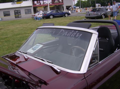 1970 Ford Ranchero - Maroon convertible interior with custom text on the windshield and racing seats visible.
