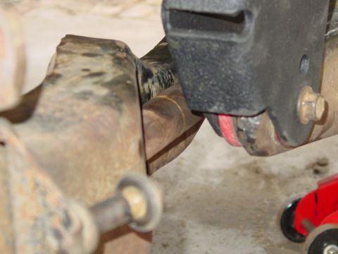 1994 Ford Bronco - Suspension part detail, possibly from a Ford Bronco, with visible red bushing.
