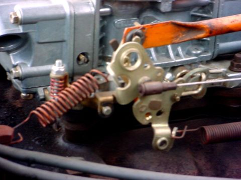 1992 Ford Mustang - Carburetor linkage components, including springs and an orange lever, are shown in detail.
