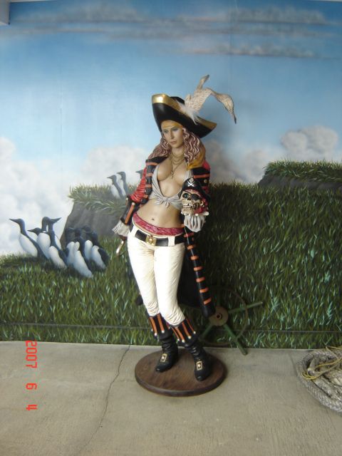 1993 Ford Bronco - A statue of a female pirate holding a skull is displayed against a painted background.