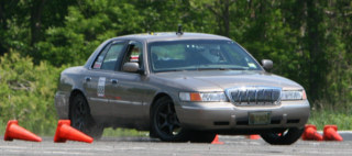 2001 Mercury Grand Marquis - A 2001 Mercury Grand Marquis is shown during a timed event on a track with cones.