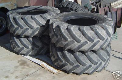 1991 Ford Bronco - Several large, heavy-duty tractor tires are stacked on a pallet outdoors.