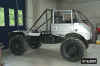 1991 Ford Bronco - This custom-built vehicle features a prominent roll cage and oversized wheels, suggesting off-road capabilities.