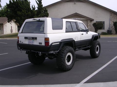 1985 Toyota 4Runner - This modified 1985 Toyota 4Runner features a white body with black fender flares and a white camper shell.