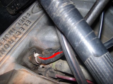 1986 Ford Bronco - Detail of an engine part showing 'ELECTRONIC FUEL INJECTION' text.