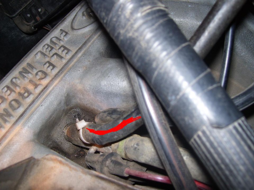 Close-up of engine component with 'ELECTRONIC FUEL INJECTION' text