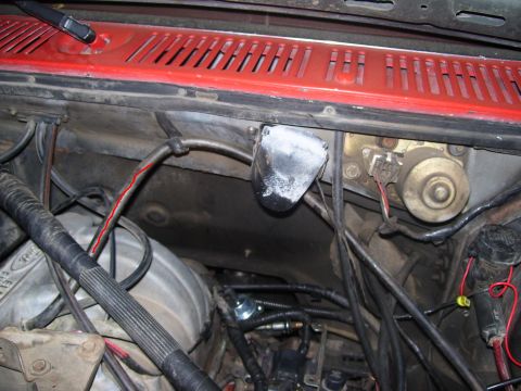 1986 Ford Bronco - This image shows a section of a vehicle's engine bay, focusing on wiring and mechanical components.