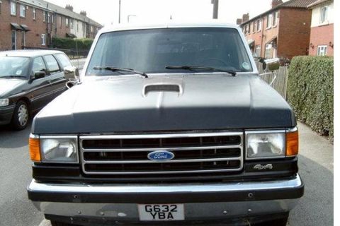 1990 Ford Bronco - This Ford F-150 pickup truck, likely from the late 1980s, is parked on a residential street.