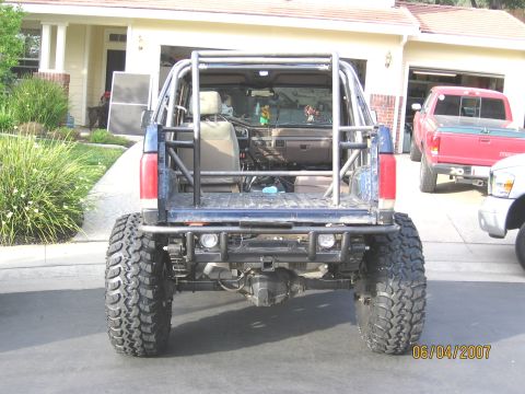 1994 Ford Bronco - This modified SUV, likely a 1992 model, has a custom roll cage and oversized tires, differing from the claimed 1994 Ford Bronco.