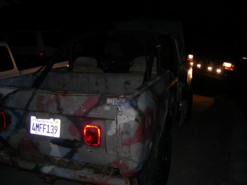 1994 Ford Bronco - This camouflaged SUV is seen from the rear, displaying a California license plate.