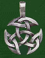 1983 Ford Ranger - A close-up of a metallic pendant an intricate Celtic knot pattern against a green background.