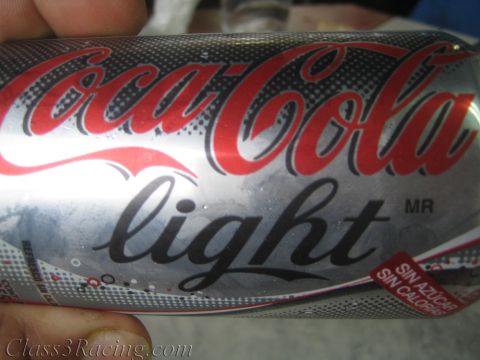 1990 Ford Bronco - Close-up of a silver Coca-Cola light can with Spanish 'sin azucar, sin calorias' text, held in someone's hand.