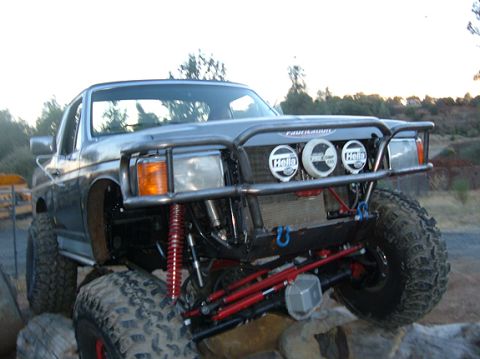 1991 Ford Bronco - This heavily modified truck features a custom roll cage, large off-road tires, and auxiliary lighting, suggesting it's built for extreme te…