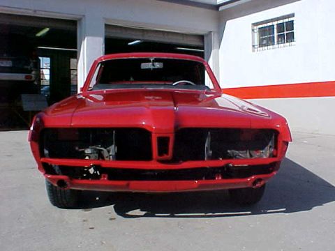 1967 Mercury Cougar - Front view of a 1967 Mercury Cougar undergoing restoration, missing its grille and headlights.