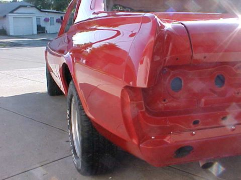 1967 Mercury Cougar - Rear view of a red 1967 Mercury Cougar with its bumper removed, revealing the chassis.