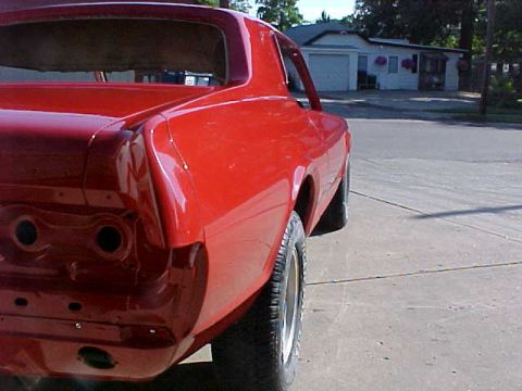 1967 Mercury Cougar - Rear view of a red 1967 Mercury Cougar, showing the quarter panel and taillight housing.
