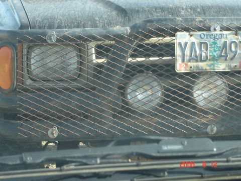 1993 Ford Bronco - Truck front with custom grille guard and auxiliary lights, Oregon license plate visible.