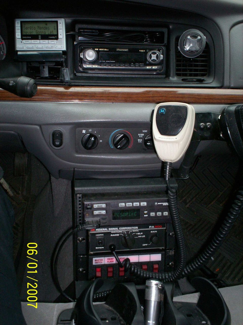 Police car interior with radio equipment and a date stamp of 06/01/2007
