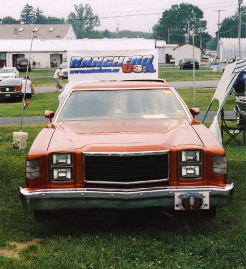 1979 Ford Ranchero - This orange pickup truck has a distinctive grille and a bull skull on its license plate frame.