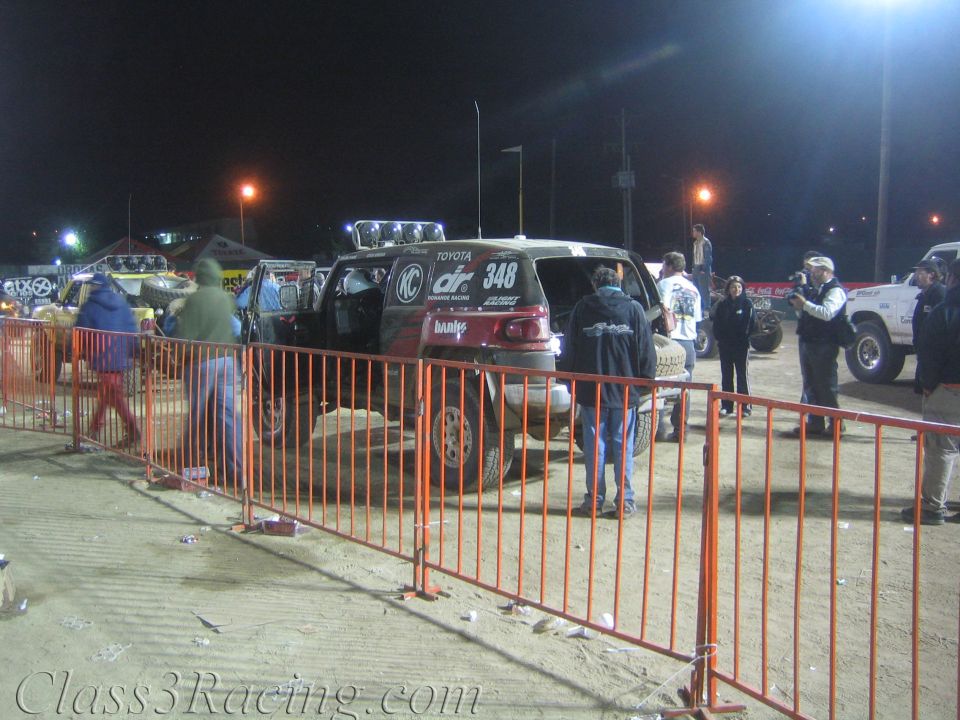 Toyota Donahoe Racing truck number 348 behind orange fencing at night