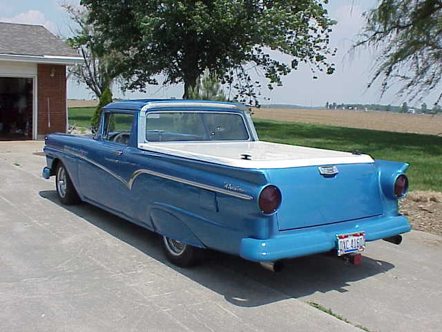 Blue 1957 Ford Ranchero pickup truck, rear 3/4 view. License plate reads DXC 4160