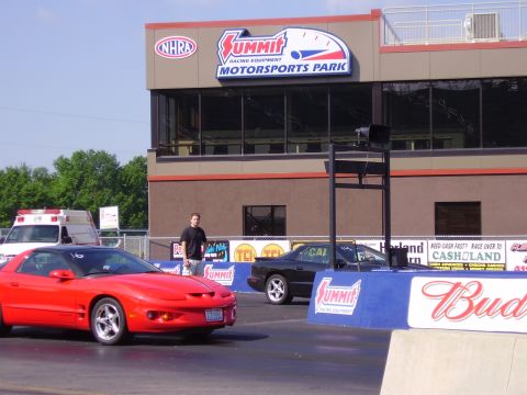 1988 Ford Mustang - Two cars are lined up at Summit Motorsports Park, with an ambulance visible in the background.