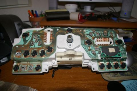 1986 Ford Bronco - The backside of a vehicle's instrument cluster shows its intricate circuitry and connection points.