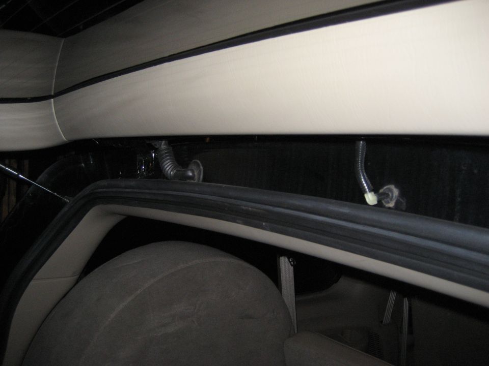 Interior rear cargo area with spare tire and wiring harness