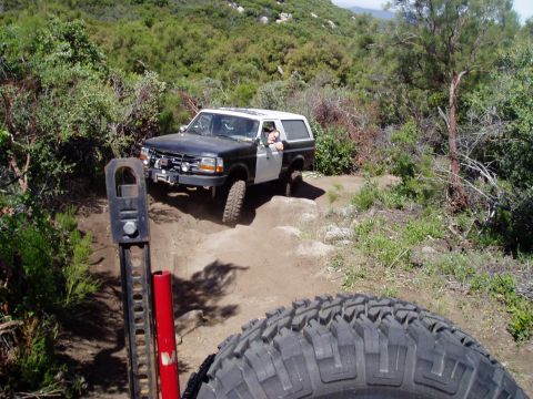 1994 Ford Bronco - Ford Bronco tackling an off-road trail with steep inclines and rocky terrain.
