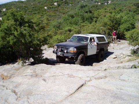 1994 Ford Bronco - This two-tone 1994 Ford Bronco navigates a challenging off-road course.