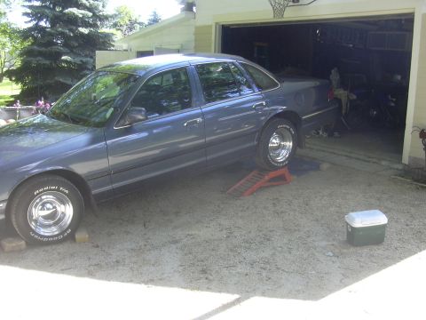 1996 Ford Crown Victoria - Blue 1996 Ford Crown Victoria positioned on ramps for service.