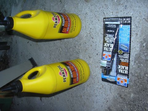 1996 Ford Crown Victoria - Two bottles of Pennzoil SAE 80W-90 gear lubricant and a tube of Permatex Ultra Black gasket maker are shown on a concrete surface.